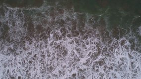 Aerial of breakers at a beach after the sunset. Pacific Ocean, South America