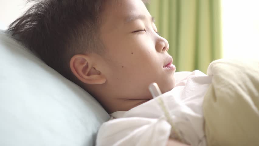 4k Young boy sick and sleep on a bed taking care by his mom in a bedroom.