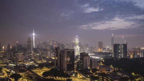 4k time lapse of sunrise night to day at Kuala Lumpur city skyline. Pan right