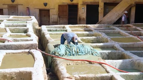 Fes, Morocco, Africa - November 04 2018 : A man hardworking on processing leather inside the Chouara Tannery of Fes