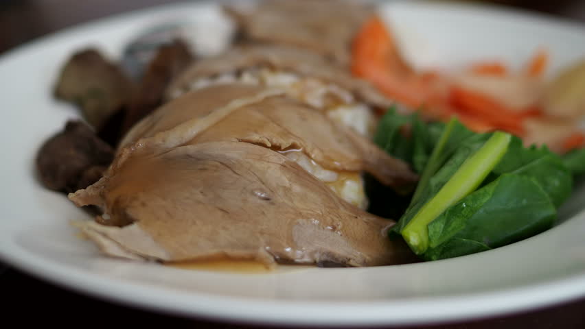 Thai food, Duck rice 
there are vegetables and duck meat on the face. and pouring the sauce into the dish