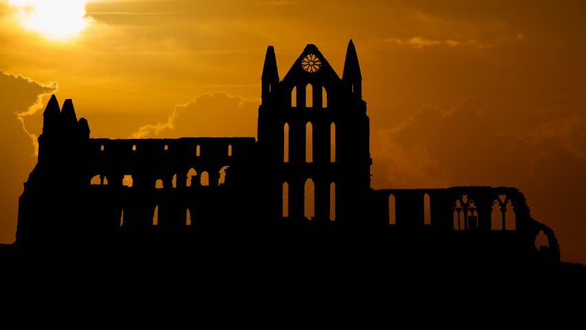 Whitby Abbey Castle at Sunset, a Ruined Benedictine monastery sited on Yorkshire, England, UK. The Gothic church which Inspired Bram Stoker to write his most Famous Novel Dracula Royalty-Free Stock Footage #1023853321
