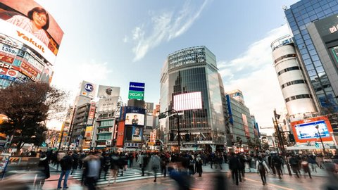 Tokyo, Japan - Jan 10, 2019: 4K UHD time-lapse of Shibuya crossing, crowded people and car traffic transport across intersection. Tokyo tourist attraction, Japan tourism, or Asian city life concept