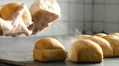 man breaks hands hot fresh bread