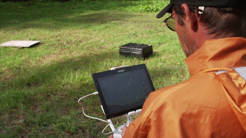 Cameraman operates the quadrocopter which makes aerial videos of Sikhote-Alin Nature biosphere Reserve founded for endangered Siberian tiger in 1935. Russia