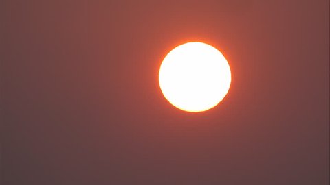 Sunrise on morning, red sunny on dark sky, hot summer season climate weather, close up big sun and ray. Heat extreme on nature environment, red orange and dark sky background, big sunshine and red ray