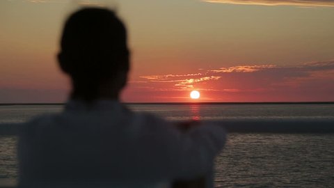 Man looking at the horizon in the sunset