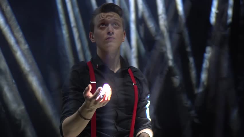 Man in ray of light on a black background