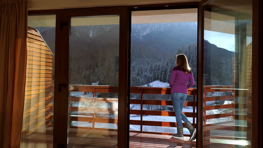 Young woman relaxing in a mountain chalet in winter time | Shutterstock HD Video #1023893128