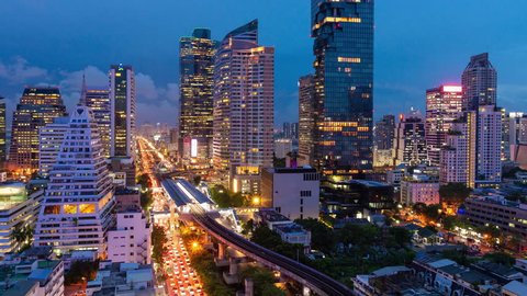 BANGKOK-JUNE26,2018: Day to night time lapse of modern building in business zone during rush hour at Bangkok,Thailand.Bangkok is the most populated city in Southeast Asia.