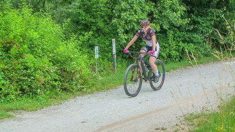 DOMZALE, SLOVENIA - 20. JUNE 2018;PUMP TRACK AMATEUR PRACTICE This young woman is cycling on a nature path on a beautiful spring day.