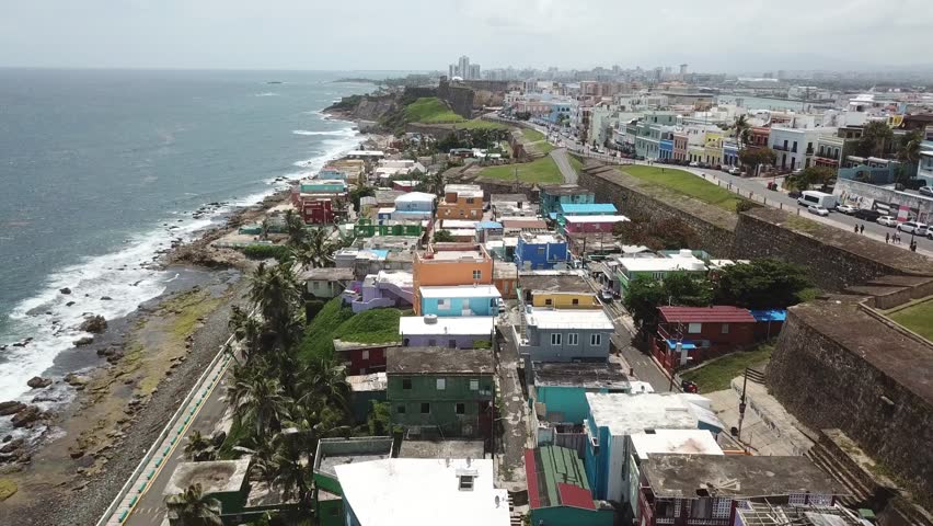 AERIAL: Flying by the coast between Santa Maria Cemetery and Castillo de San Cristobal.