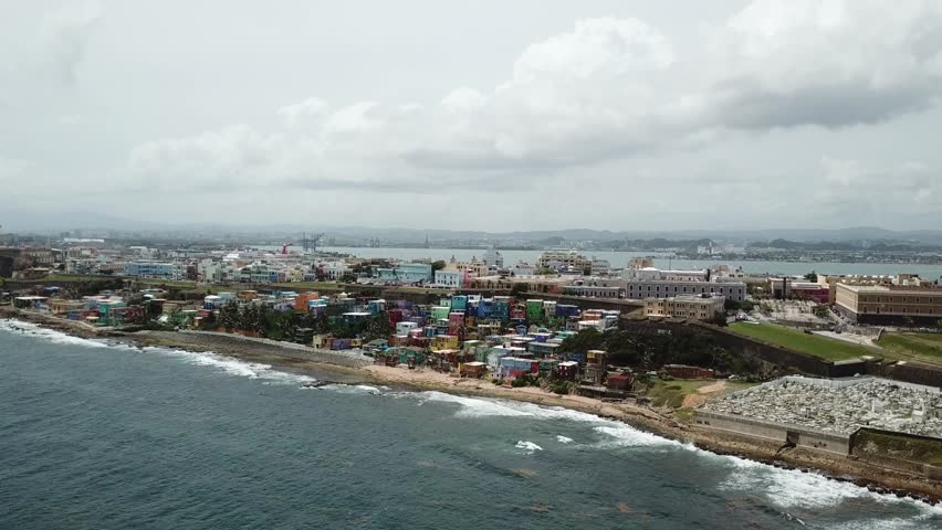 AERIAL: Flying in from the ocean, towards the Santa Maria Cemetery and the colorful houses on the beach.