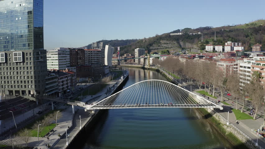 Aerial; drone view of Bilbao capital of Basque country; city panorama with modern architecture and contemporary art objects; new life of ancient city; the combination of old town and modern urbanism Royalty-Free Stock Footage #1023911644