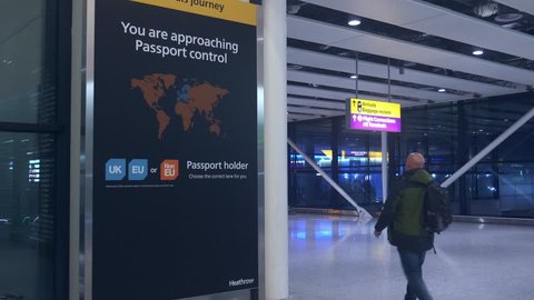 London Heathrow, UK, Feb 5, 2019: Passengers walks past sign prior to immigration passport control pointing towards queues for UK, EU and Non-EU passport holders - UK is set to leave the EU in 2019