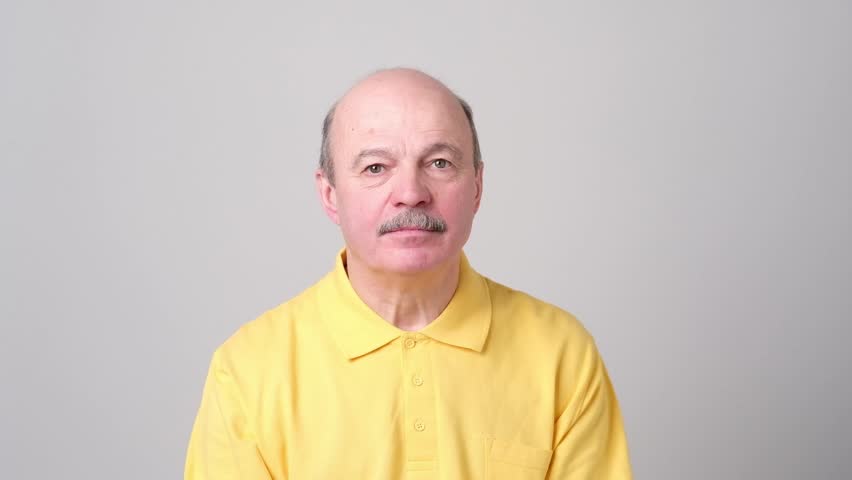 surprised senior bald man can not believe his eyes. Unbelievable sales and low prices concept