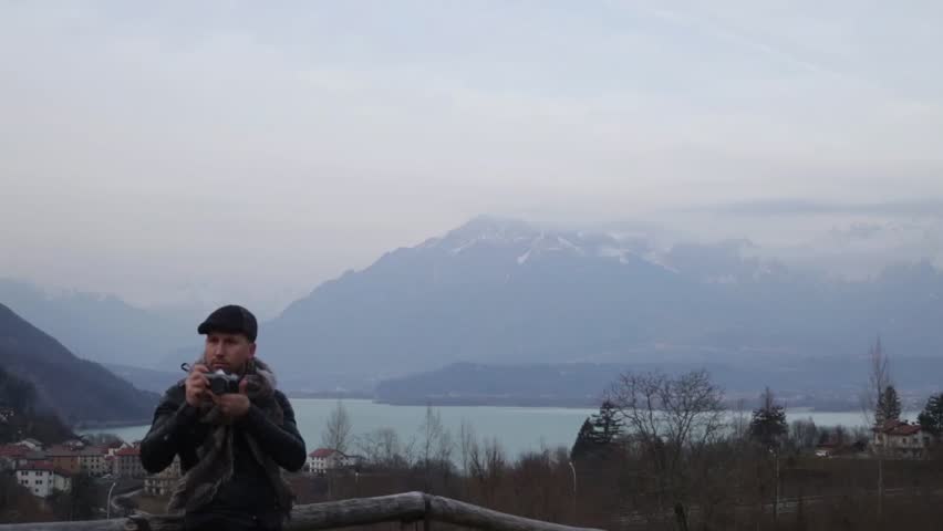 A photographer of nature prepares a beautiful panoramic mountain sho