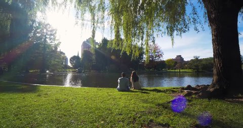 Couple Sits by Lake, Lakeside Romance in Boston Public Gardens Park