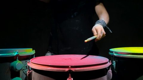 Pink holi powder drum , slow motion. black background.