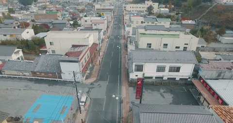 Aerial Drone Tracking Shot Following a Road Revealing the Ghost Town from the Fukushima Nuclear Powerplant Disaster.
