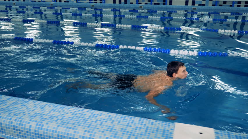A swimmer with prosthesis training in a pool, side view. | Shutterstock HD Video #1023933461
