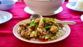 4K time lapse video of stir fried spicy cat fish, Thailand.