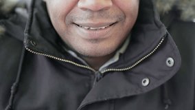 Close up shot of Afro-American middle-aged mans mouth biting lips slightly and smiling. Lifestyle concept