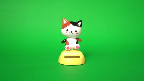 Cat doll dancing on green screen background.