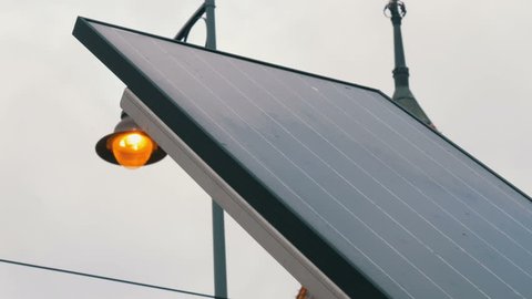 Solar panel on a city street in cloudy weather. Energy saving and environmental protection