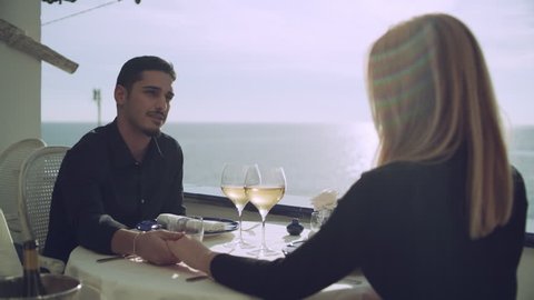 Romantic date of a loving couple hold hands while enjoying the view in the Amalfi Coast. Medium shot on 8k helium RED camera.