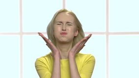 Pretty adult woman foooling around. Funny middle-aged woman slapping her cheeks and making funny grimace. Checkered window background. - Powered by Shutterstock - Get 15% off with code: PIKWIZARD15