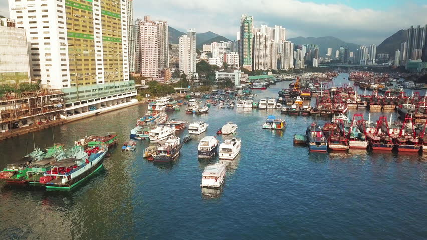 Drone flying overlooking view of the Traditional Fishing Trawlers in the Aberdeen Bay and Ap Lei Chau Bridge in the Southern part of Hong Kong Island
