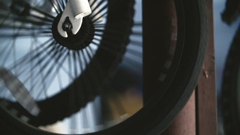 Slow motion: An old mountain bicycle's front tire spins freely while hanging