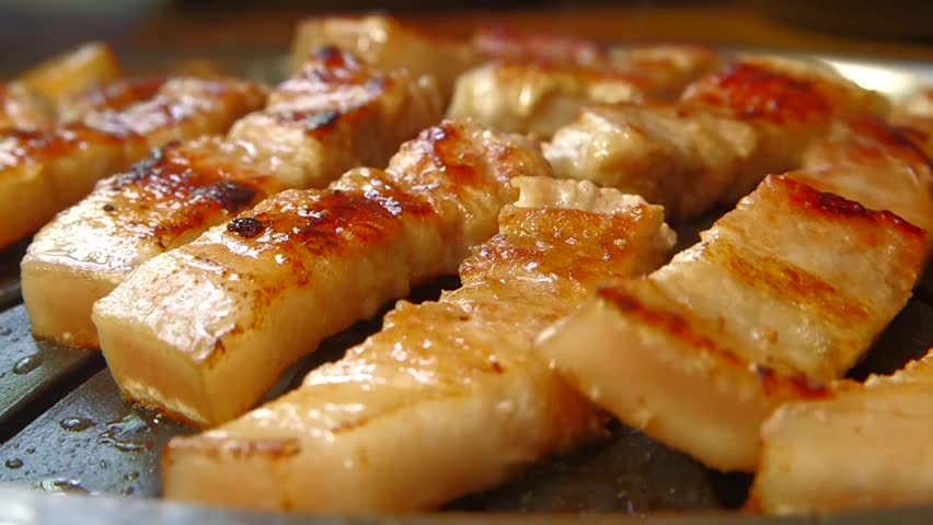 Cooking pork belly on a grill - korean style pork bbq, samgyupsal Royalty-Free Stock Footage #1024001006