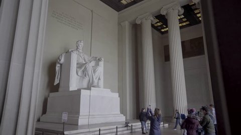 Washington, D.C., USA, February 3, 2019:   Statue of President Abraham Lincoln as Visitors Take Photos - The famous statue of President Abraham Lincoln sits inside the Lincoln Memorial as tourists and