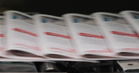 Newspapers, tabloids, print plant factory,magazine transports on conveyor belt line after printing units
