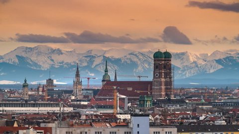 Munich skyline timelapse in background alps mountains view form top, Munich cathedral and marienplatz square view, Germany.