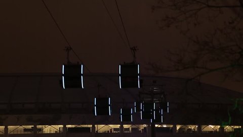 Cable car with moving cabins at night, timelapse
