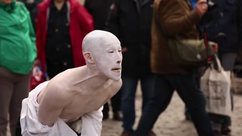Schwerin, Germany - april.2017. Street Theater. The actor of the Japanese theater plays in the performance. His face is painted white, he is wearing a national costume. The actor is grimacing. Panoram