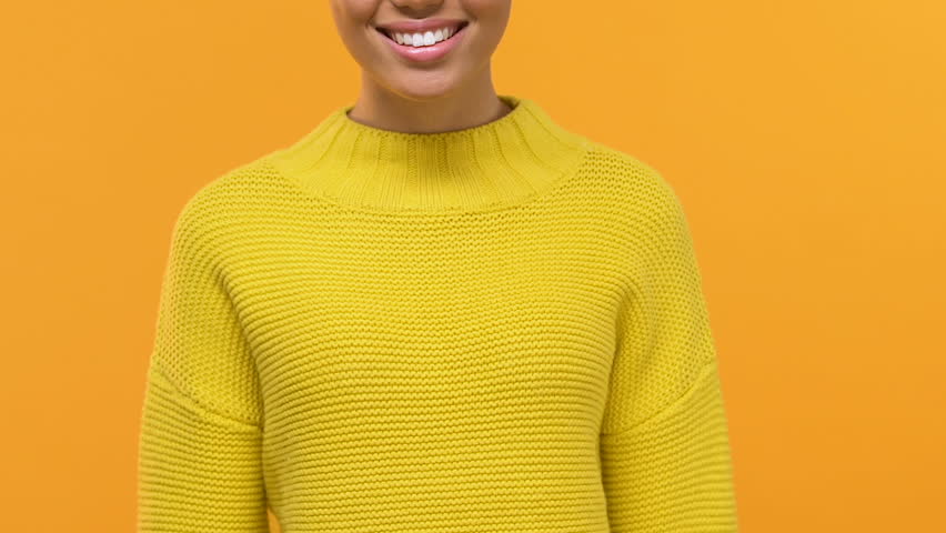 Stylish young female with purchase bags showing credit card, shopping cash back
