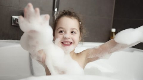 Cute little girl taking bath
