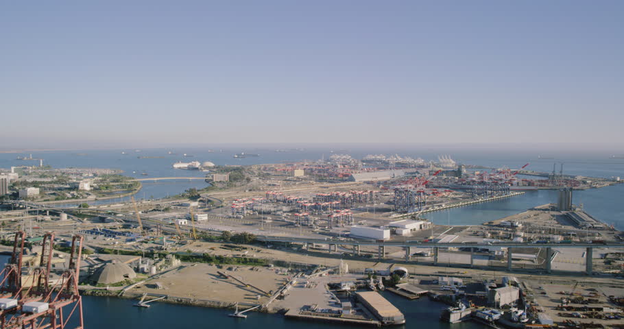 Long beach harbor and freeway helicopter wide shot POV AERIAL view of ocean port and ships in Los Angeles, California United States