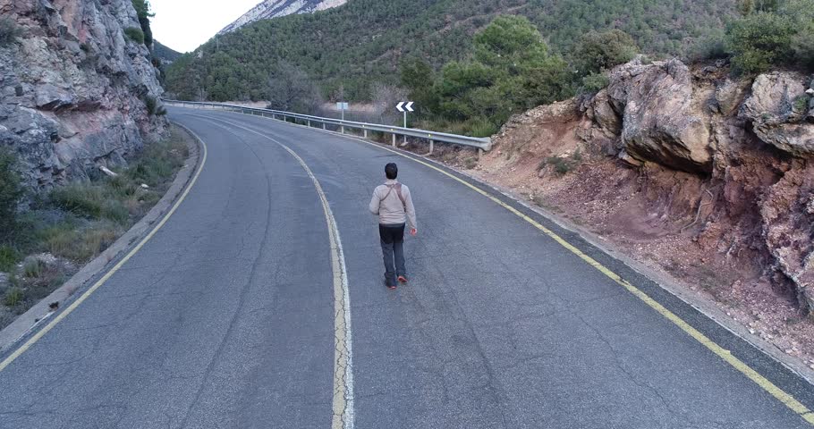 Aerial view of a man walking on the road