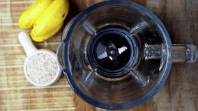 Fresh ripe banana pouring in a blender, super slow motion video