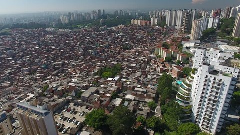 São Paulo, São Paulo / Brazil - 01/26/2019: Aerial view of Paraisópolis slum and luxury builidings of Giovanni Gronchi Avenue, a symbol of brasilian social contrast