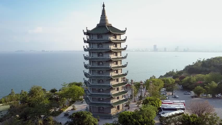 wonderful upper motion around temple complex with pagoda and huge buddha statue on coast hill top in Vietnam