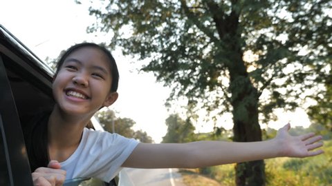 Happy Asian Girl Playing on Window Car, Family Traveling on Countryside, Slow motion shot
