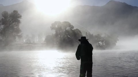 Fly fisherman in the river (slow motion)