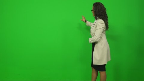 Weather Woman Presents Forecast Against a Green Screen