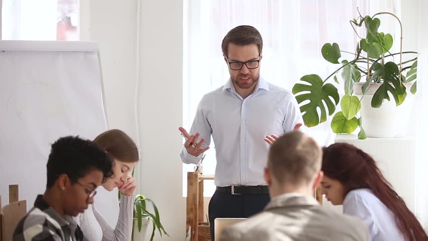 Angry boss chief shouting at group office meeting scolding criticizing employees mad about corporate problem or business failure, executive manager ceo yelling during team staff meeting in boardroom Royalty-Free Stock Footage #1024093883